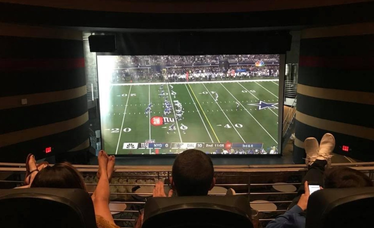 Football on the big screen Guests watching football on the big screen at the Times Theater