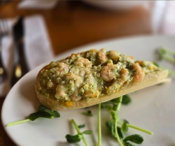 Open-faced seafood melt with microgreens at Sisu Brewing Astoria