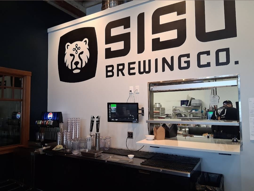 Sisu Brewing Co logo wall and bar inside the taproom