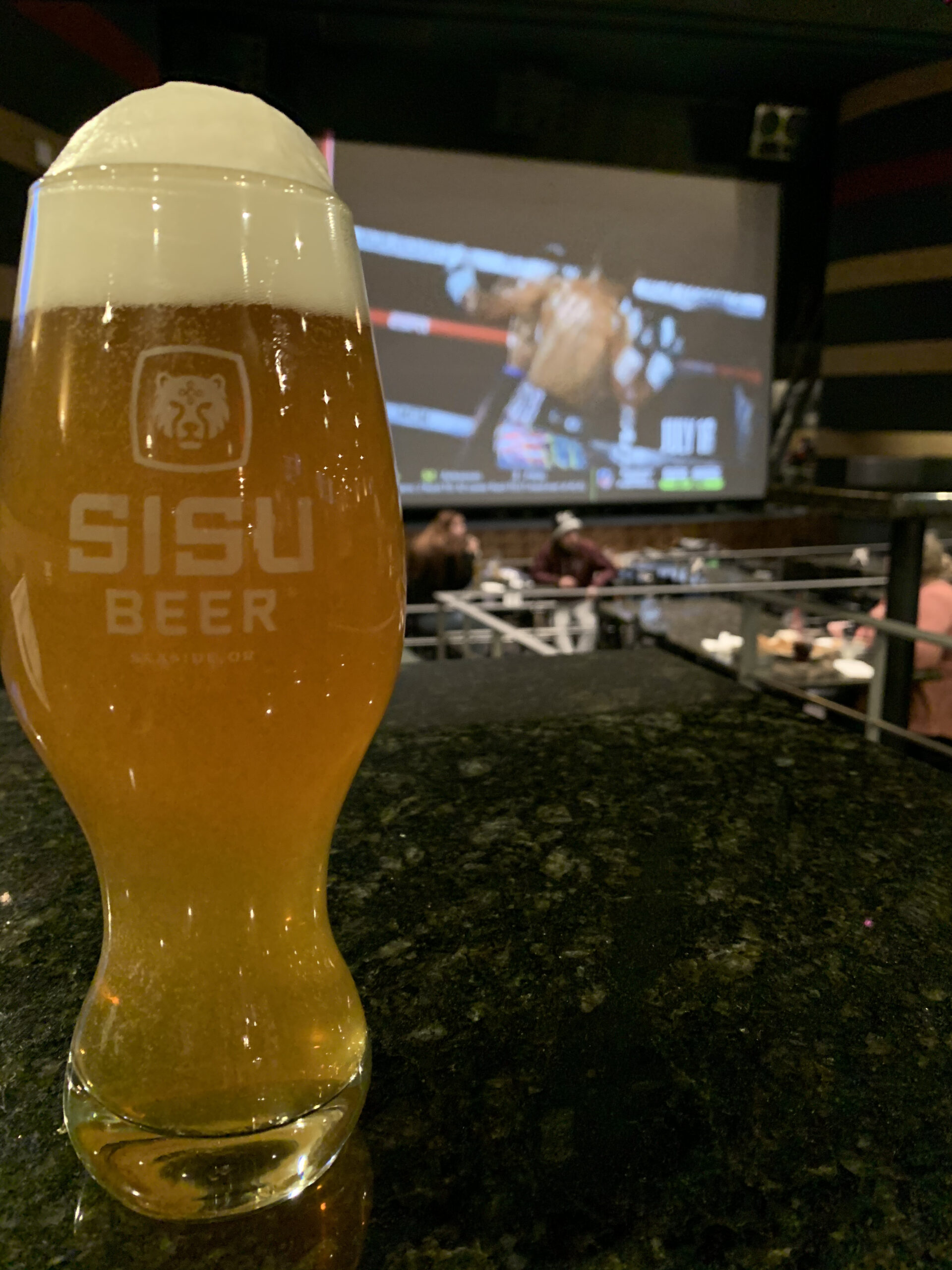 Pint of Sisu IPA with boxing on the big screen at the Times Theater