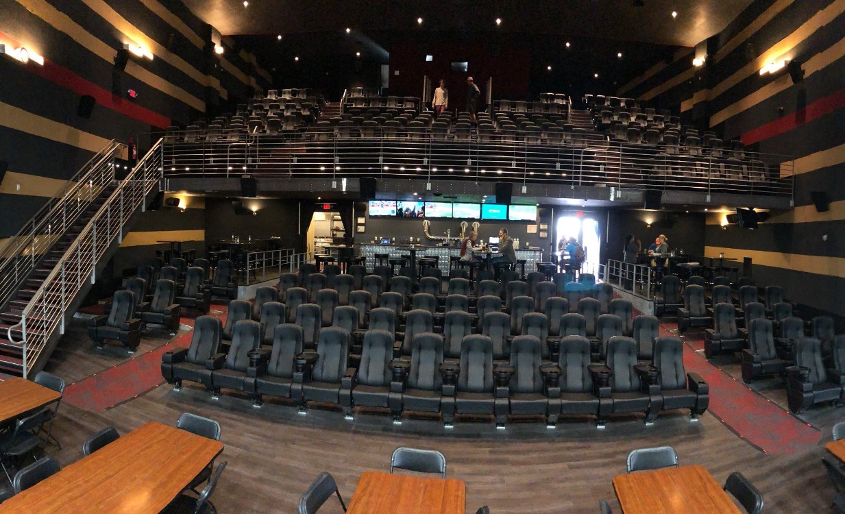 Times Theater auditorium Restored Times Theater auditorium with stadium seating and taproom tables