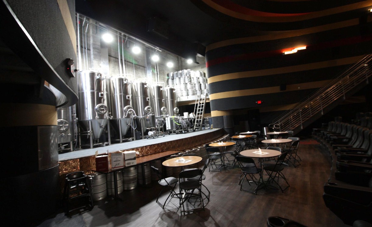 Times Theater taproom Times Theater taproom with brewery tanks on stage and tables on the floor