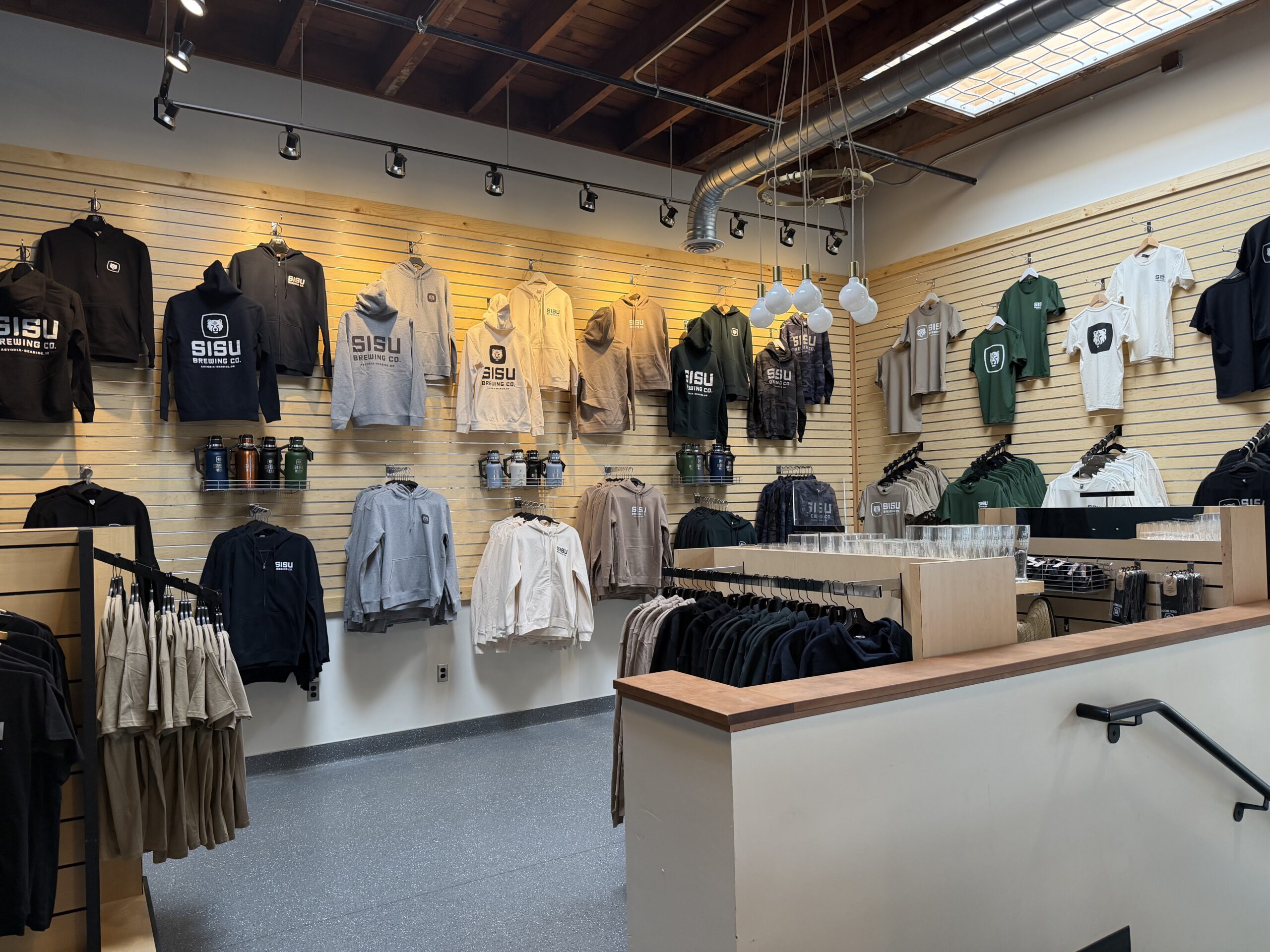 Inside the Sisu Brewing Co gear shop — hoodies, tees, growlers, and pint glasses